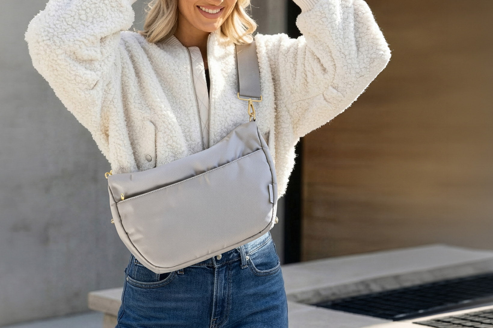 Woman wearing a Canvelle crossbody bag resting at her hip
