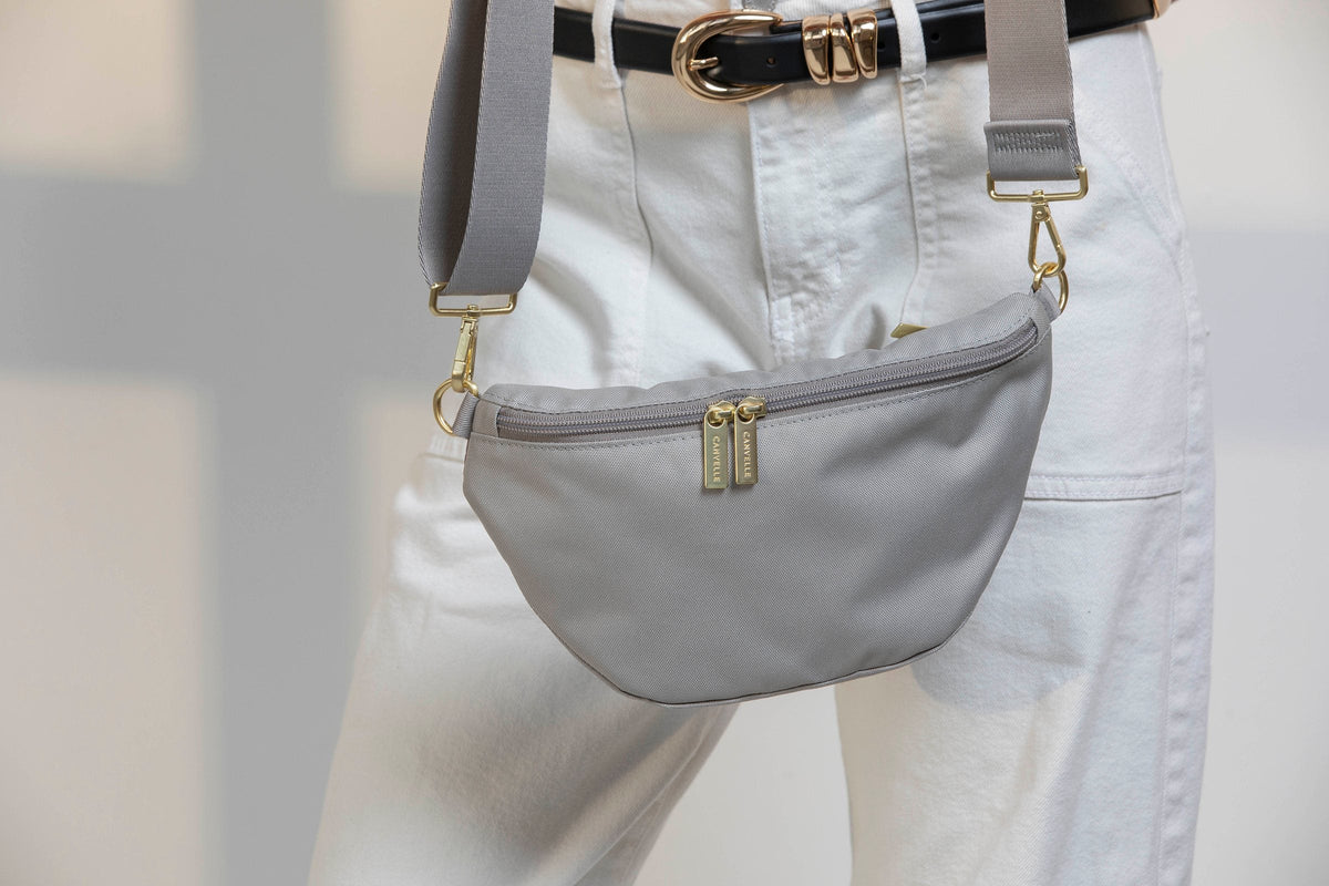 Grey Canvelle Bum Bag worn crossbody at the hip with white jeans