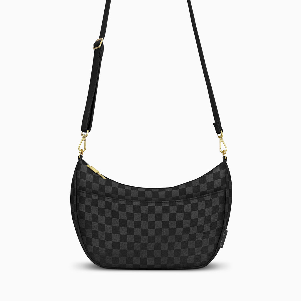Canvelle Crescent Bag in medium black checkered canvas with gold hardware – front view.