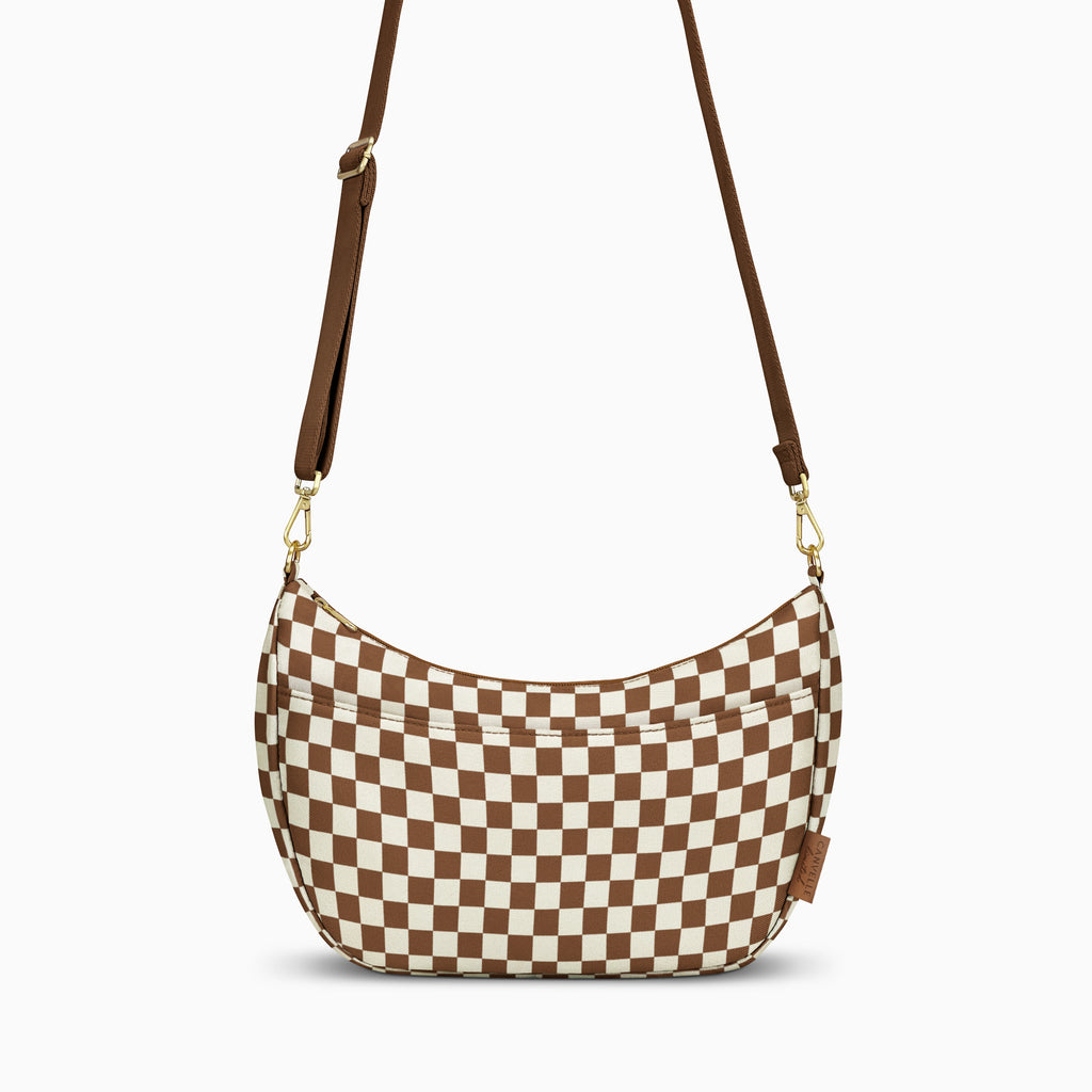 Canvelle Crescent Bag in medium brown and white checkered canvas with gold hardware – front view.