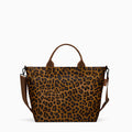 Canvelle Zip Crossbody Tote in medium brown leopard print recycled polyester canvas with black hardware - Front view.