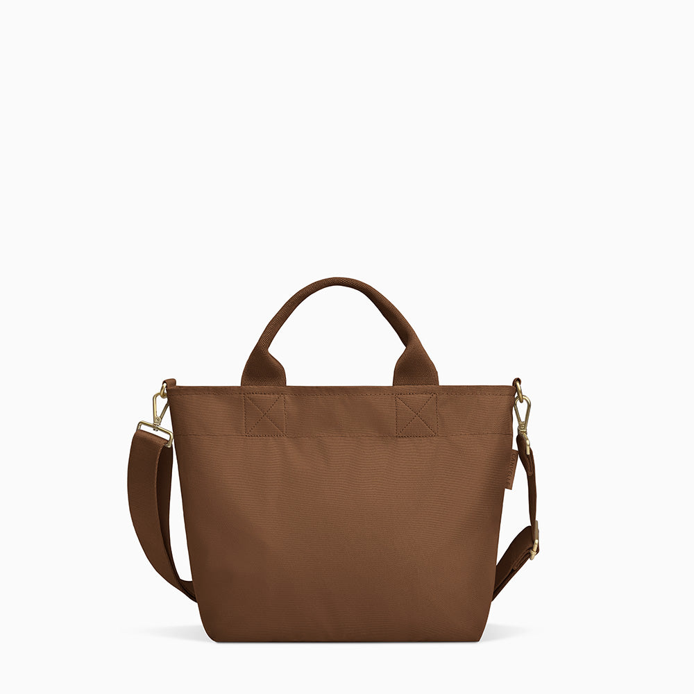 Canvelle Zip Crossbody Tote in small brown recycled polyester canvas with gold hardware - Front view.