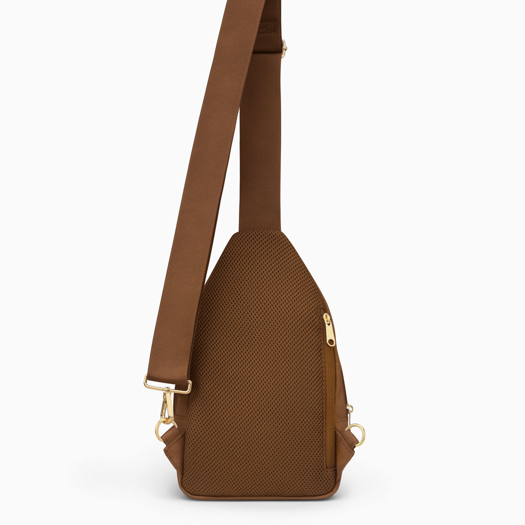 Canvelle City Sling Bag in brown - Back view showing breathable mesh padding, hidden anti-theft zipper pocket, and convertible strap attachments.