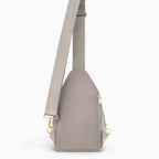 Canvelle City Sling Bag in grey - Back view showing breathable mesh padding, hidden anti-theft zipper pocket, and convertible strap attachments.