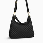 Canvelle Hobo Handbag in large black checkered canvas - Angled view with crossbody strap showing depth and side profile.