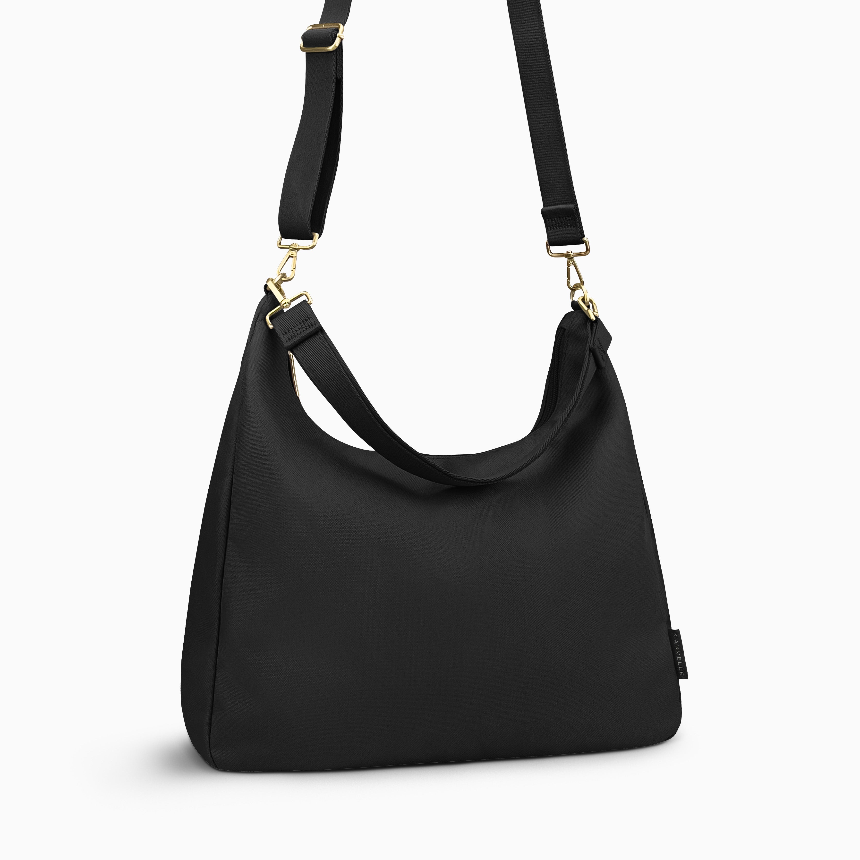 Canvelle Hobo Handbag in large black canvas - Angled view with crossbody strap showing depth and side profile.