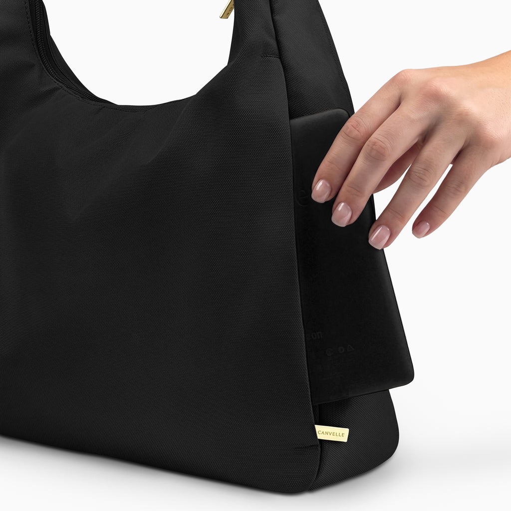 Large black Canvelle Hobo Handbag back view showing the plain exterior slip pocket, fitting an 8-inch e-reader.