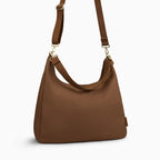 Canvelle Hobo Handbag in large brown canvas - Angled view with crossbody strap showing depth and side profile.