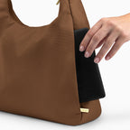 Large brown Canvelle Hobo Handbag back view showing the plain exterior slip pocket, fitting an 8-inch e-reader.