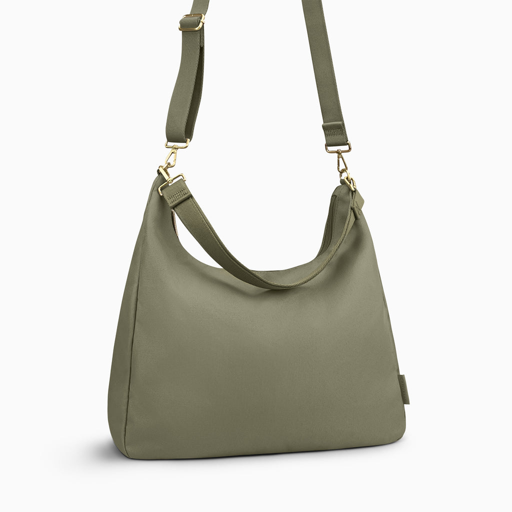 Canvelle Hobo Handbag in large olive canvas - Angled view with crossbody strap showing depth and side profile.