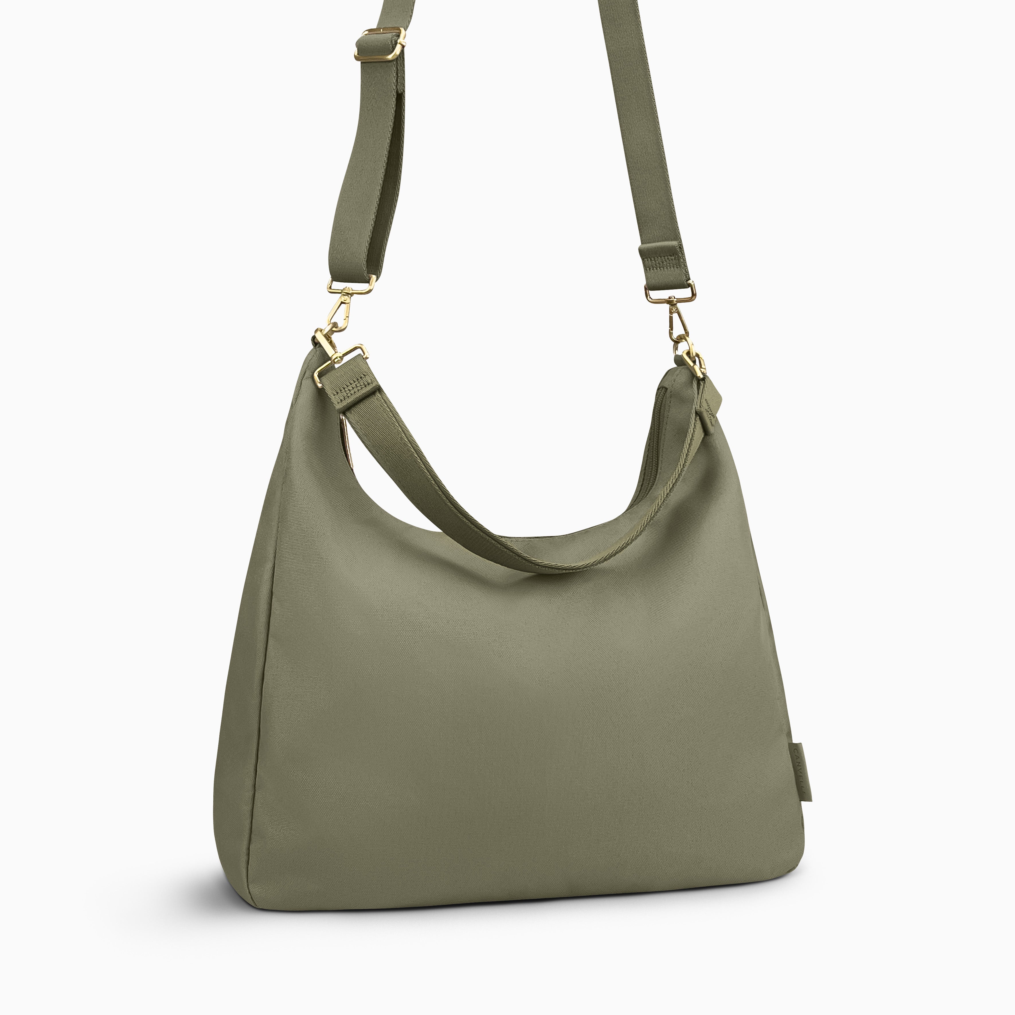 Canvelle Hobo Handbag in large olive canvas - Angled view with crossbody strap showing depth and side profile.