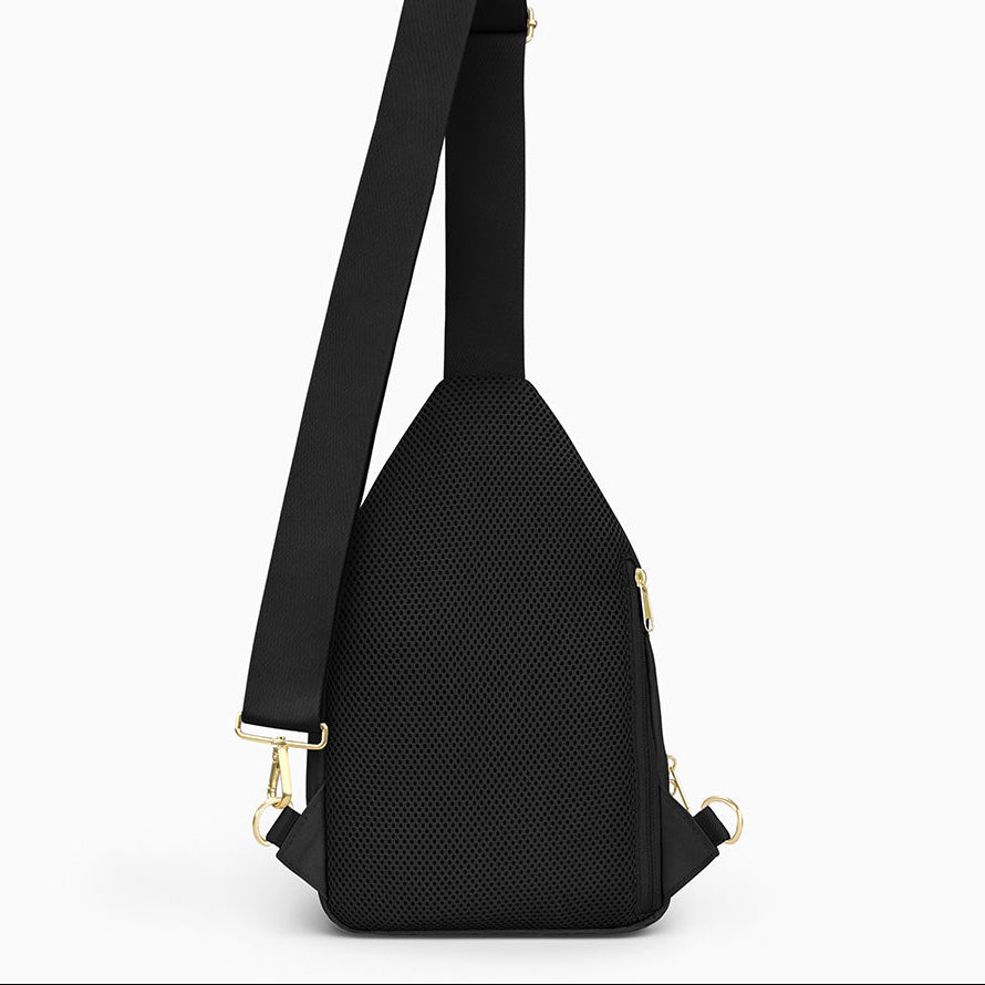 Canvelle City Sling Bag in medium black - Back view showing breathable mesh padding, hidden anti-theft zipper pocket, and convertible strap attachments.