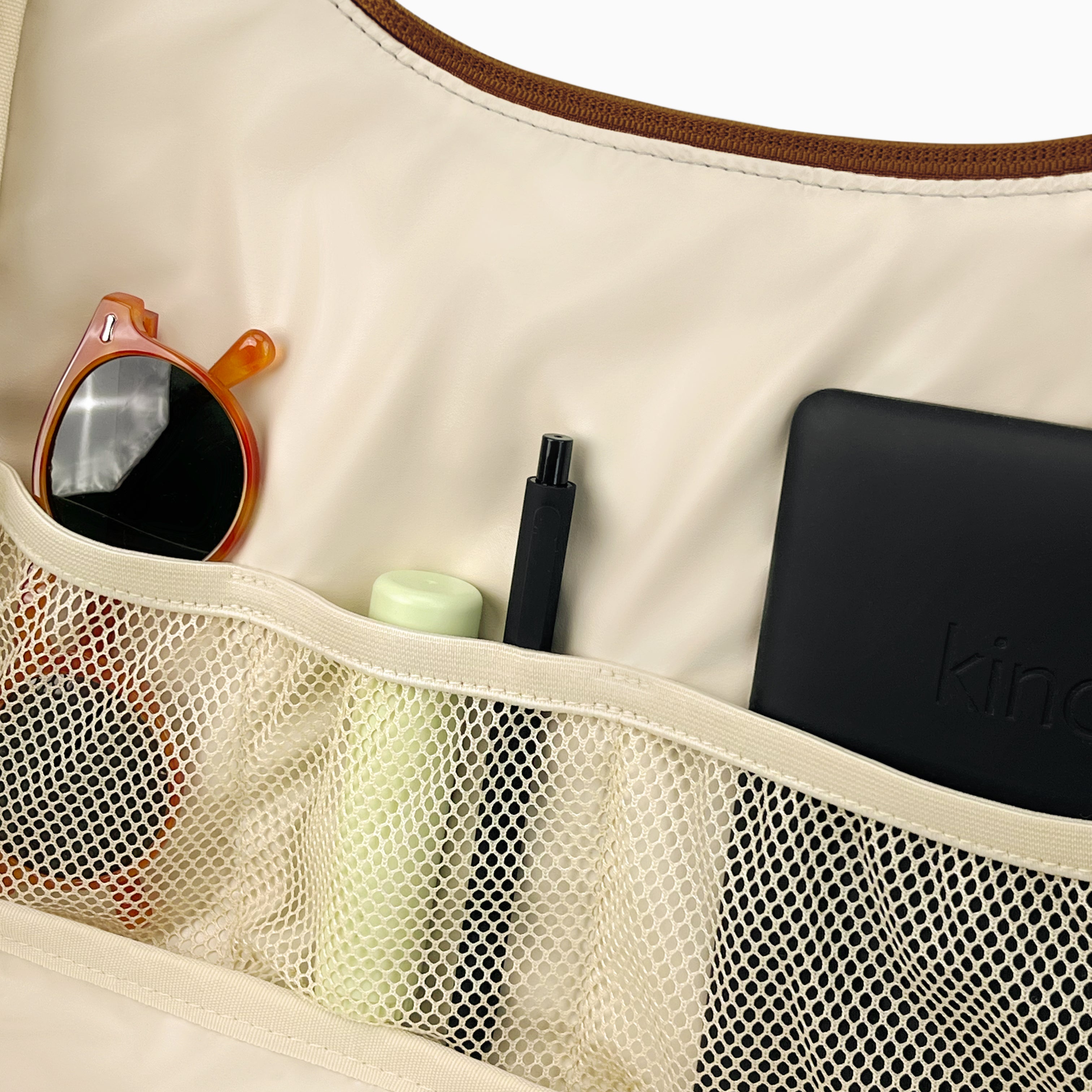 Open medium Canvelle Brown Hobo Handbag showing the wipeable water-resistant lining and three elastic mesh pockets.