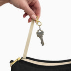 Keys on the built-in key clip inside the large black checkered Canvelle Hobo Handbag.