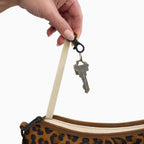 Keys on the built-in key clip inside the large brown leopard Canvelle Hobo Handbag.