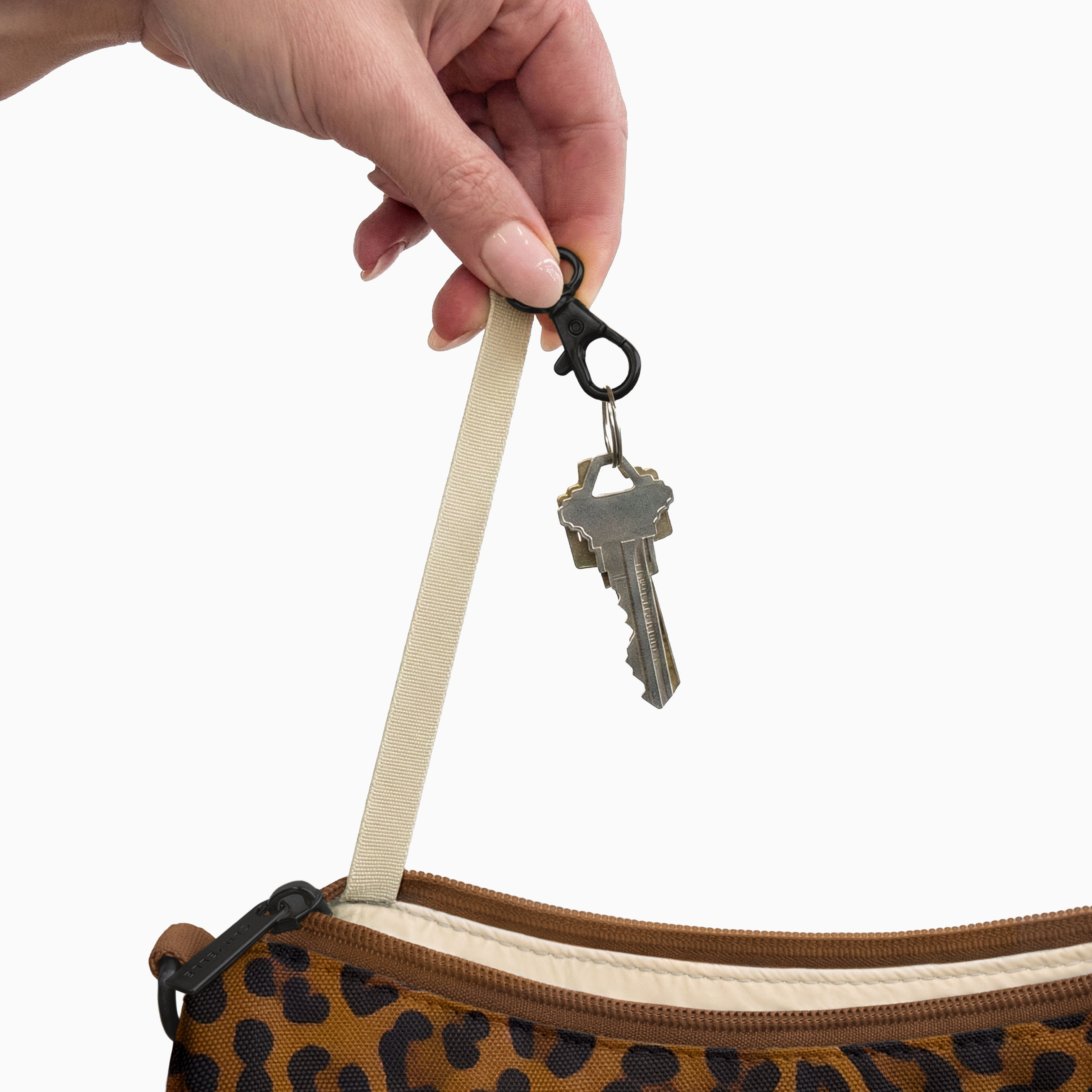 Keys on the built-in key clip inside the large brown leopard Canvelle Hobo Handbag.