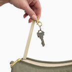 Keys on the built-in key clip inside the large olive Canvelle Hobo Handbag.
