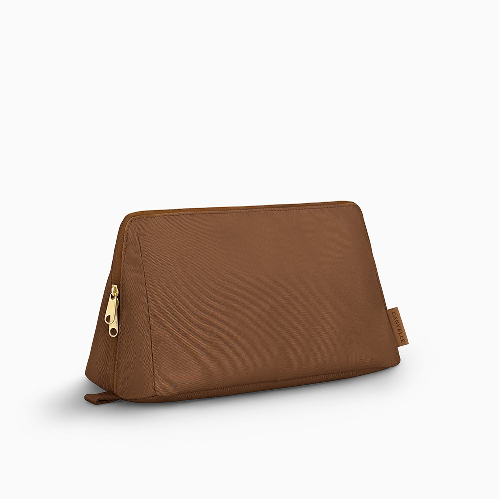 Canvelle Toiletry Bag in large brown recycled polyester canvas with gold hardware - Front view.