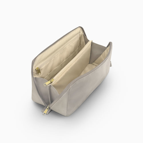 Open Canvelle Toiletry Bag in grey canvas showing beige water-resistant lining, internal zipper pocket, and structured dividers.