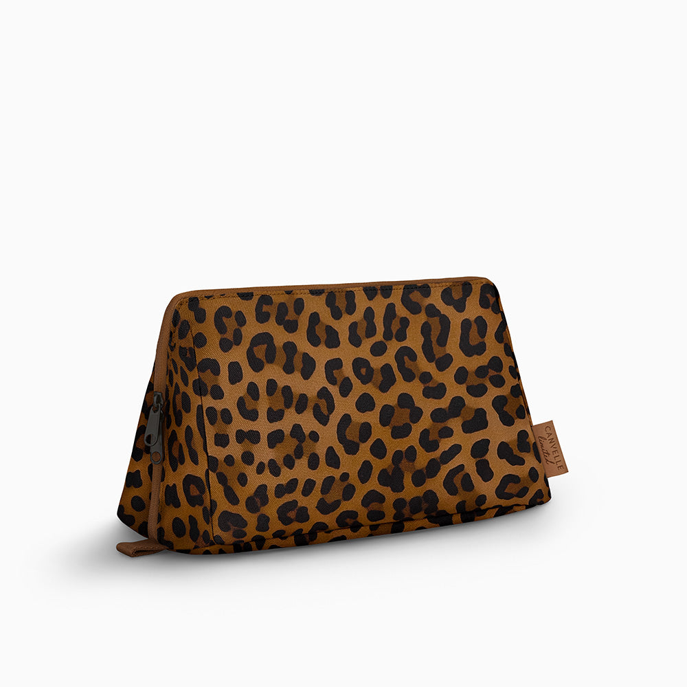 Canvelle Toiletry Bag in large brown leopard print recycled polyester canvas with black hardware - Front view.