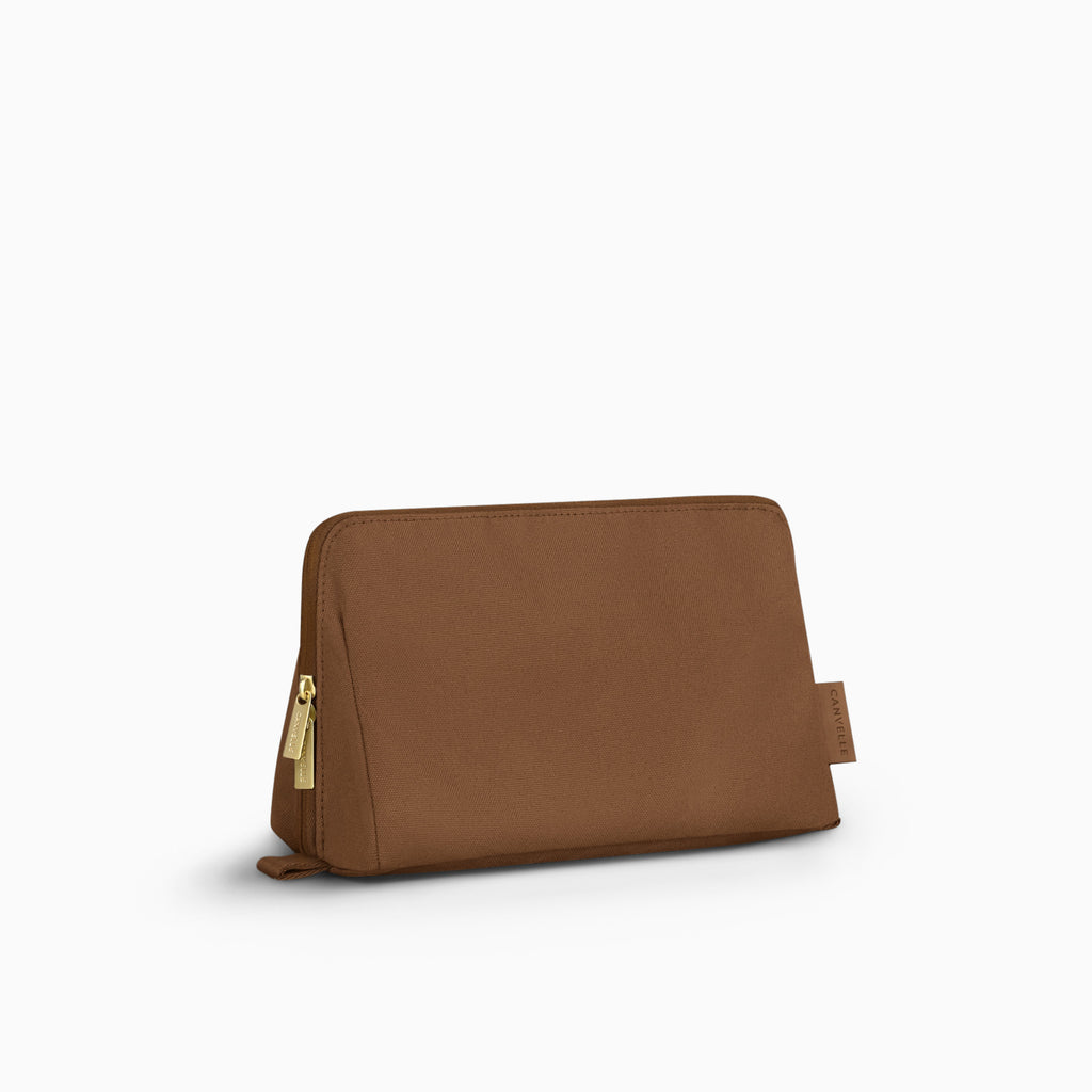 Canvelle Toiletry Bag in medium brown recycled polyester canvas with gold hardware - Front view.