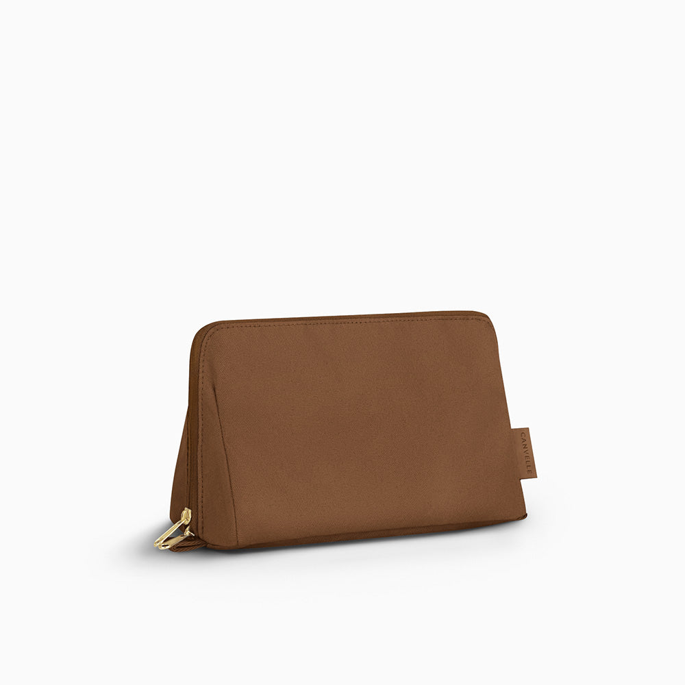 Canvelle Toiletry Bag in medium brown recycled polyester canvas with gold hardware - Front view.